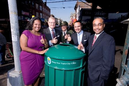 Photo Courtesy of Councilmember Julissa Ferreras Councilmember Julissa Ferreras, Department of Sanitation Commissioner John J. Doherty, Douglas Marsiglia, chief of cleaning operations, Assemblymember Francisco Moya and Senator Jose Peralta (left to right) stand around one of the 14 new litter baskets placed along the Roosevelt Avenue business corridor.