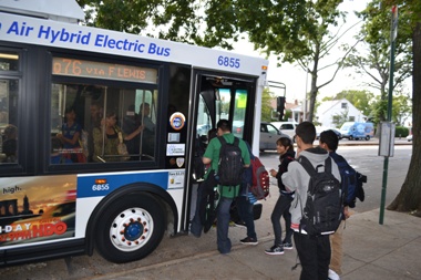 THE COURIER/Photo by Bob Doda. The Department of Education said 7th and 8th grade students must wait at an MTA bus stop down the block for the two-bus, 90-minute trip to school.