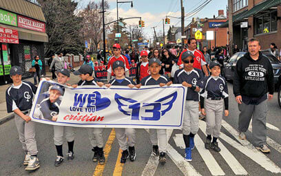 College Point Little Leaguers march for player who died