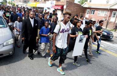 Mourners march for D’aja, 14