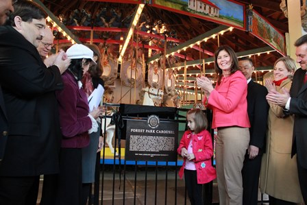 Elected officials and members of the Landmark Preservation Commission unveiled a plaque to honor the Forest Park Carousel.