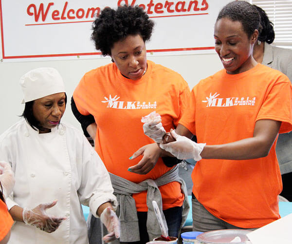 Volunteers decorate cupcakes with SE Queens elderly for MLK day