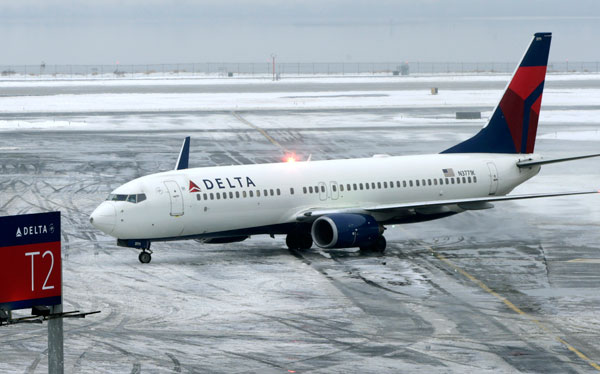 Plane skids off slick JFK runway into snowbank