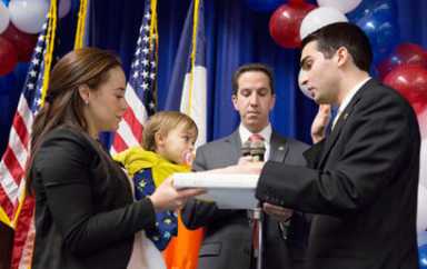 Ulrich takes oath as Dems applaud