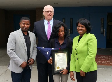 Kezia Dickson, 13, pictured with U.S. Rep. Joe Crowley and her parents after being awarded first place in the inaugural Veteran’s Day essay competition for the students in New York’s 14th Congressional District.