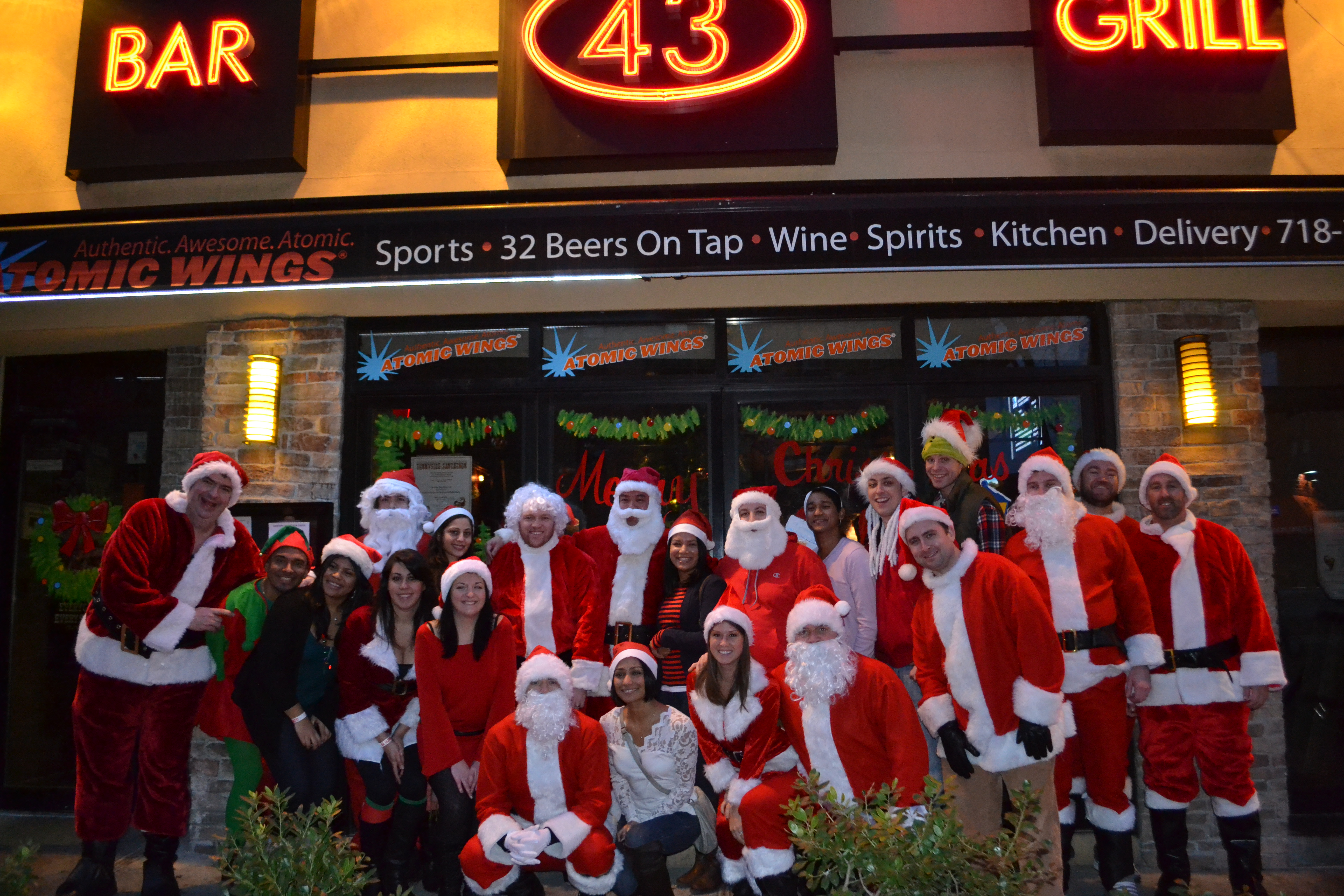 Revelers pose for photographs outside Bar 43 during a previous Santathon. Photo via Angy Altamirano