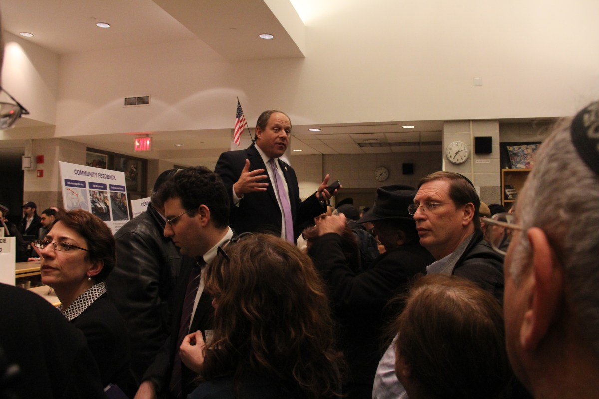 Councilman Rory Lancman attempts to sooth a tempestuous crowd.