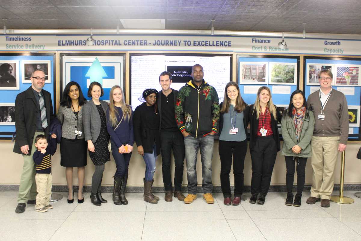 The Libertas Center for Human Rights staff and clients in front of the “New Life, New Beginning: A Photovoice Project” photo exhibition.