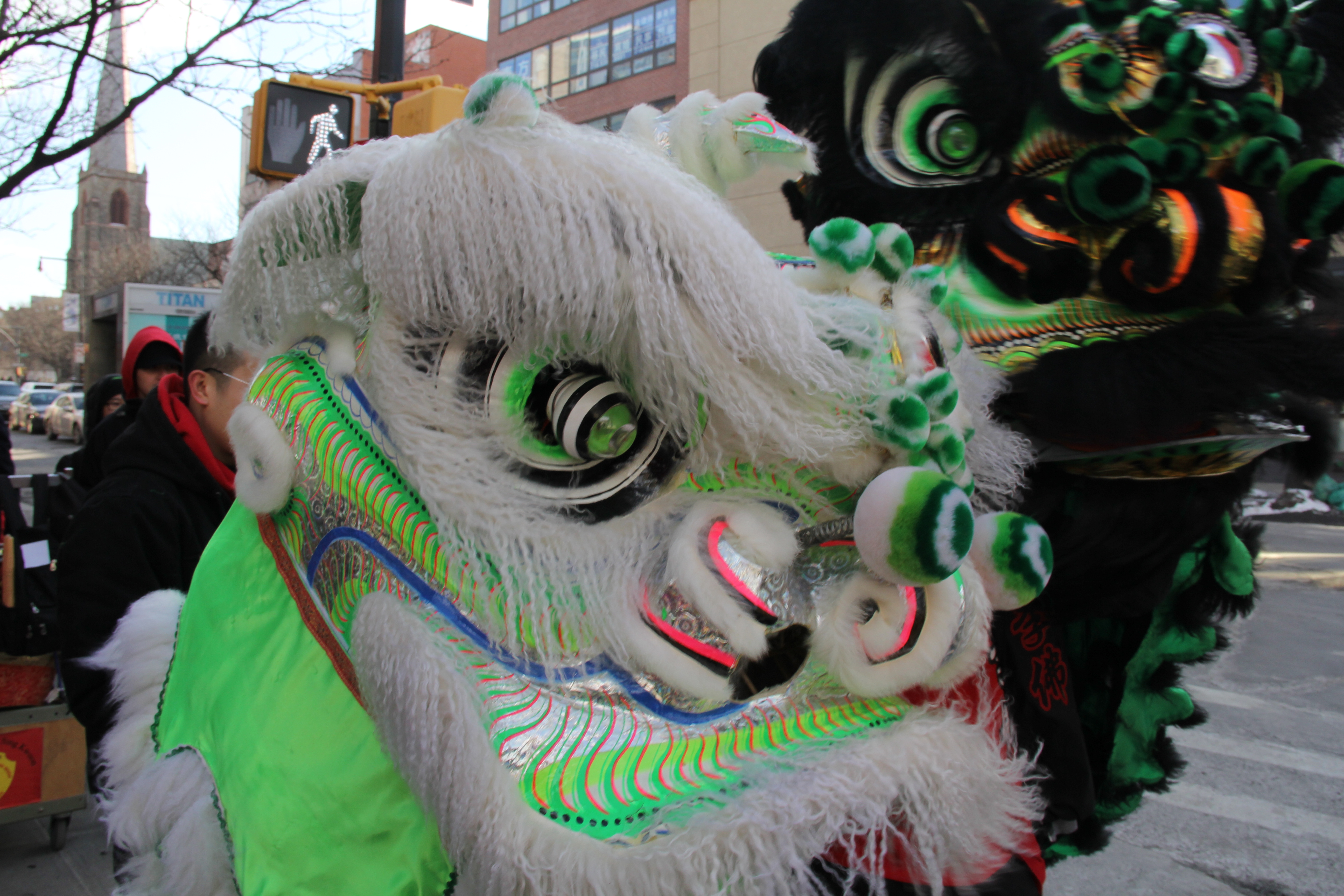 A green dragon moves through the streets of Flushing.