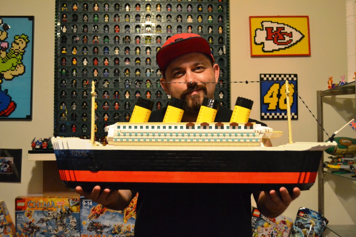 Cody Wells, the man behind C3Brix, holds his Titanic model made entirely of Legos.