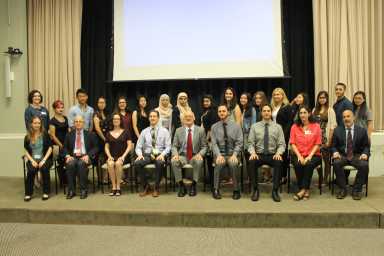 Teens who created the winning projects stand behind mental health care professionals who guided them.