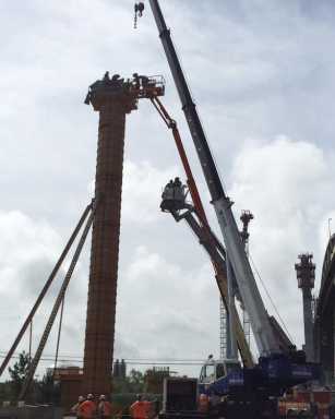 Firefighters rescued a construction worker after he passed out on top of a pillar in Maspeth.