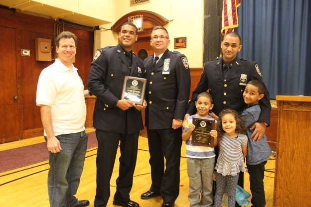 104th Precinct Community Council President Len Santoro (left) with Officer Hector Valdez, Captain Mark Wachter, Officer Carlton Coronado and their families during the Cop of the Month awards at the 104th Precinct Community Council meeting.
