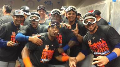 Yoenis Cespedes (foreground) and his fellow Mets celebrate their National League Eastern Division Championship following Saturday's win in Cincinnati.