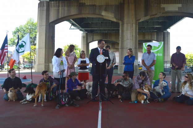 Elected officials gathered to announce the allocation of $1 million for a dog park in Astoria.