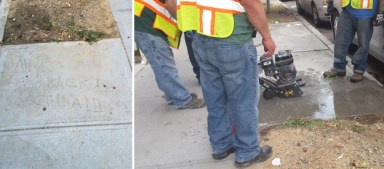 Crews from the Department of Transportation worked on Tuesday to wipe out a hateful message found on a Flushing sidewalk. The Courier blurred the slur in the left image.