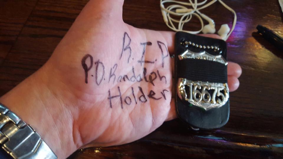 Retired NYPD officer Kieran Breen shared this photo on social media featuring his own badge alongside a memorial message.