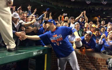 David Wright congratulates Mets fans who came to Wrigley Field to watch them sweep the Chicago Cubs and win the National League championship Wednesday night.