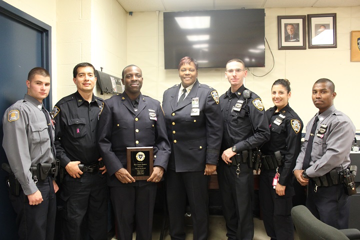 Commanding Officer Deputy Inspector Judith Harrison (center) with Cop of the Month Isaac Zamor (left) and several recent police academy graduates and recruits at the 112th Precinct's Community Council recent meeting.