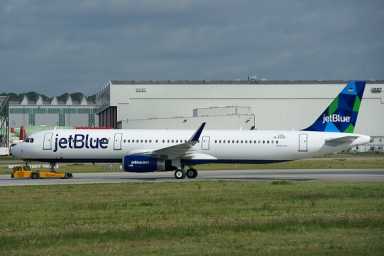 A Queens man reportedly shoved two flight attendants and punched a third.