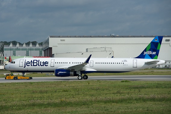 A Queens man reportedly shoved two flight attendants and punched a third.