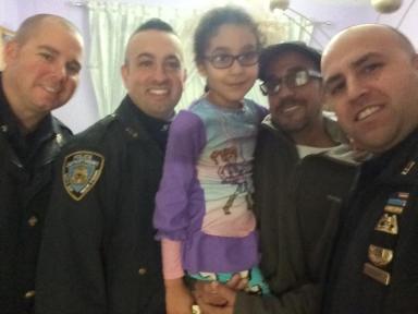 Sergeant Gergenti and Police Officers Lambert and McLouglin with 6-year-old Sarah and her father.