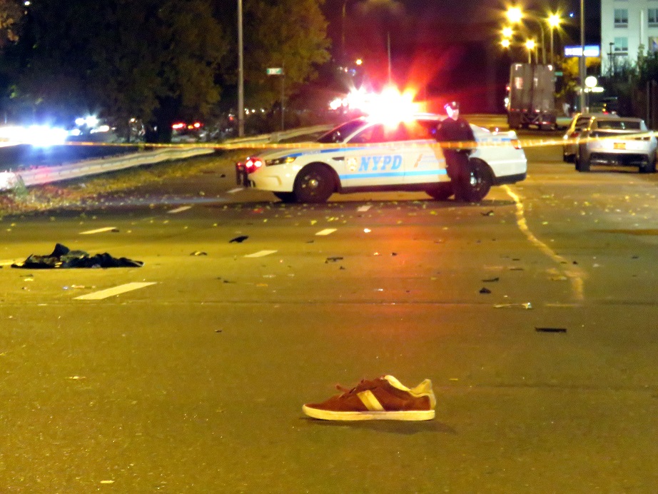 The victims shoe and clothes lie on South conduit in Queens after an unidentified male was struck and killed by a car.