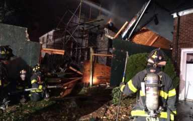 Firefighters at the scene Wednesday night of the most recent arson fire at a construction site on 67th Drive in Forest Hills.
