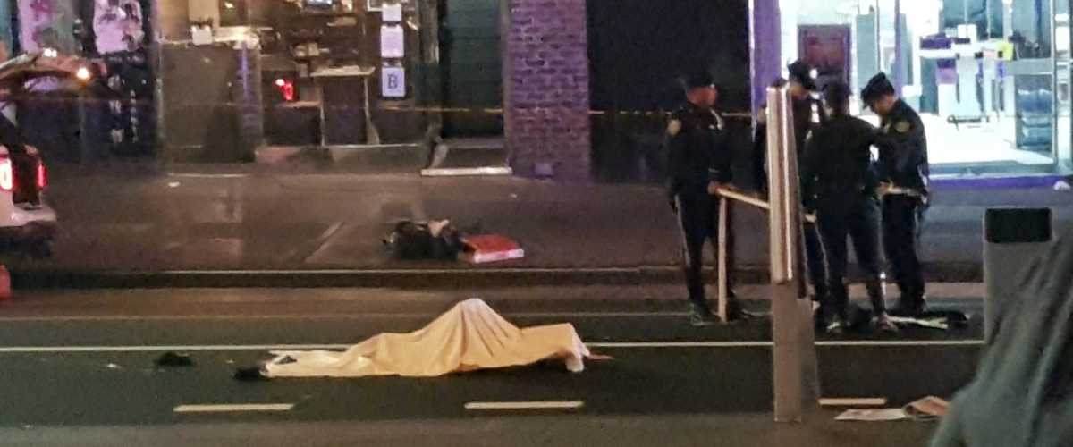 The body of a Flushing woman hit and killed by a bus Thursday night lies on Main Street.
