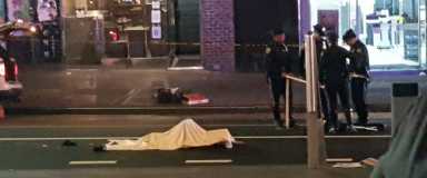 The body of a Flushing woman hit and killed by a bus Thursday night lies on Main Street.