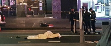 The body of a Flushing woman hit and killed by a bus Thursday night lies on Main Street.