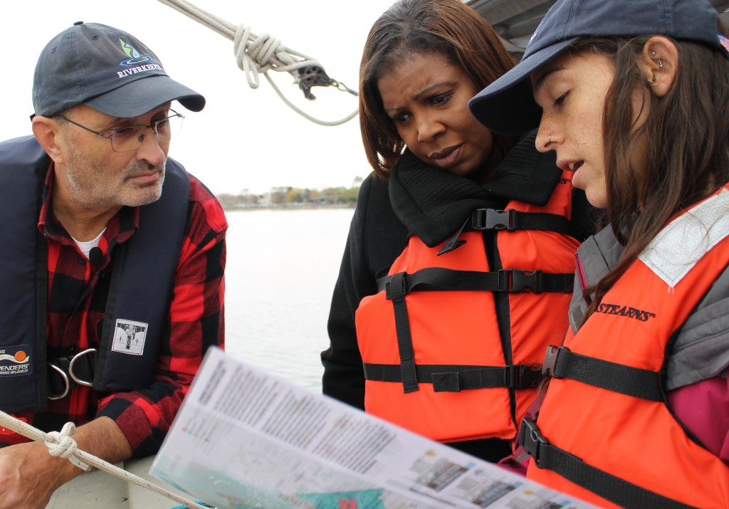 Clean water advocates use a map of New York waterways to educate Public Advocate Letitia James.