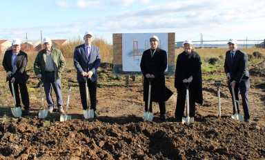 Major players involved in the development of The Bridges at Whitestone pose with shovels specially painted for the project's groundbreaking.