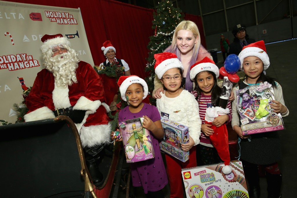Actress Abigail Breslin greeted youngsters and Santa Claus during the "Holiday in the Hangar" event on Dec. 15 at John F. Kennedy Airport.