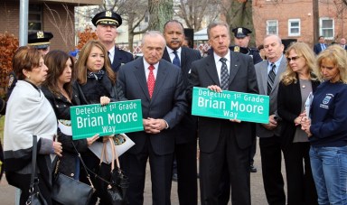 Police Commissioner Bill Bratton along with Irene and Raymond Moore, parents of the late Det. Brian Moore, renamed a Queens Village intersection in the slain officer's honor on Friday morning.
