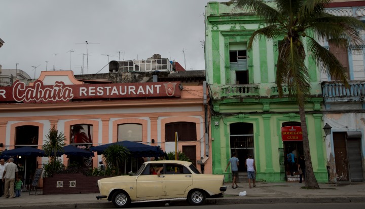 Candy colored cars and buildings brighten up a stormy day in Havana, Cuba.