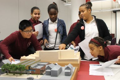 Students examine scale models of projects previously completely by the School Construction Authority and City Department of Construction and Design.