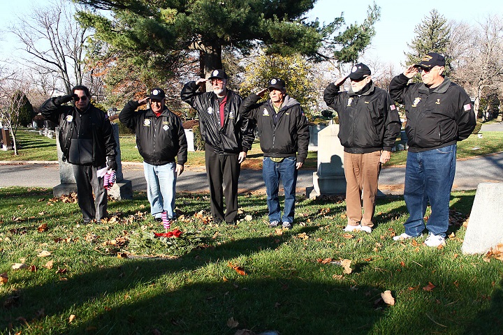 Volunteers honored veterans laid to rest at Mt. Olivet Cemetery in Maspeth this weekend by placing wreaths at their gravesites.