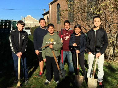 Hunter Brink (in maroon sweatshirt) with volunteers who took part in a local churchyard cleanup.