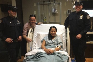 Police Officers Andrew Barton and Michael Pyzikiewicz with the parents of the newborn baby they helped deliver on the Long Island Expressway service road in Fresh Meadows on Saturday.