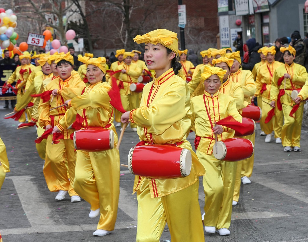 Participants march in last year's parade in Flushing.