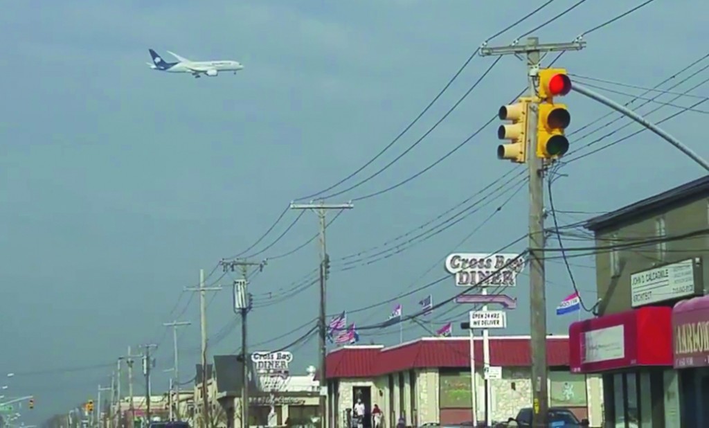 A plane flying over Cross Bay Boulevard in Howard Beach.