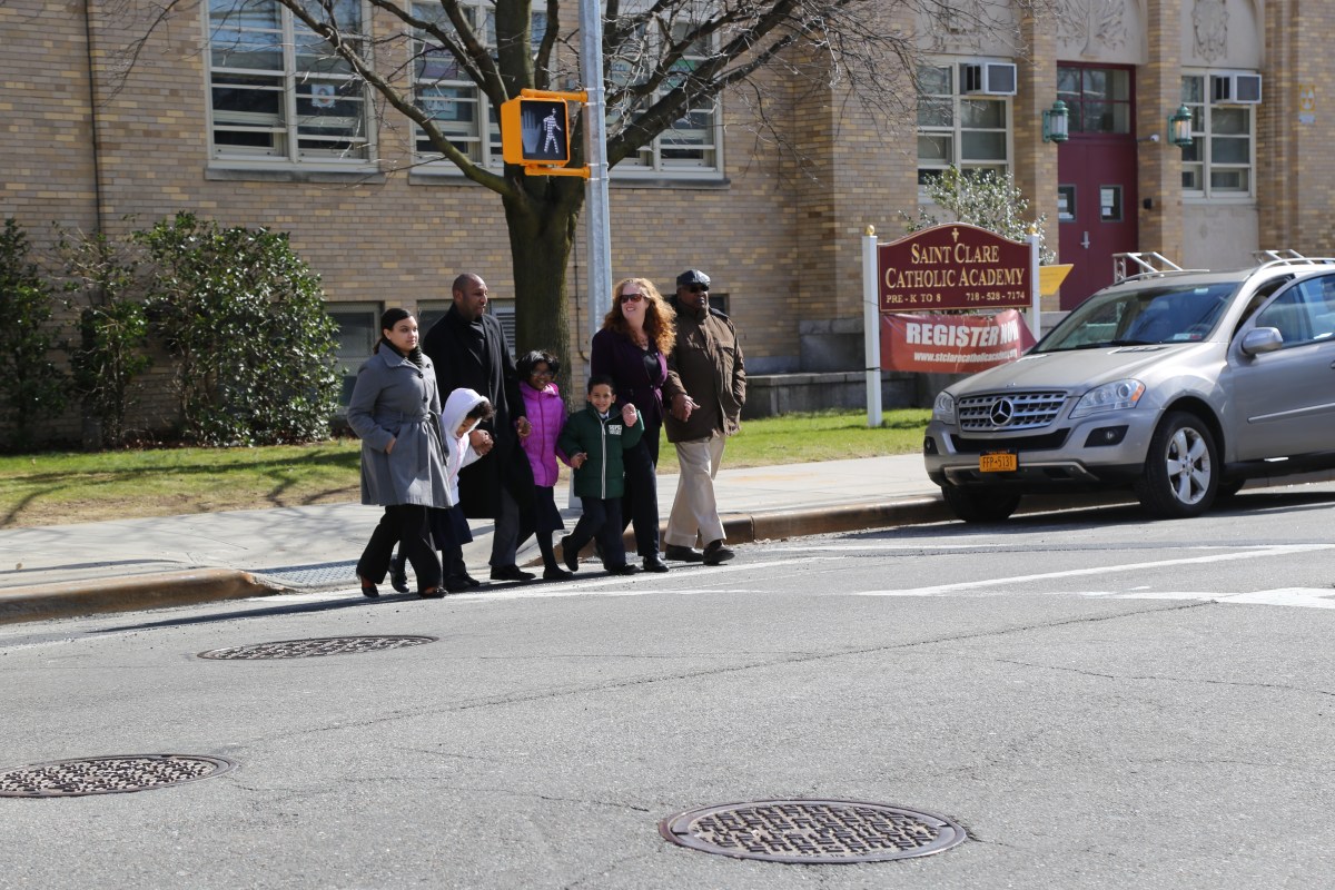 City Councilman Donovan Richards leads teachers and students from St. Clare's Catholic Academy across Brookville Boulevard near 137th Road in Laurelton, where a new traffic signal was installed.