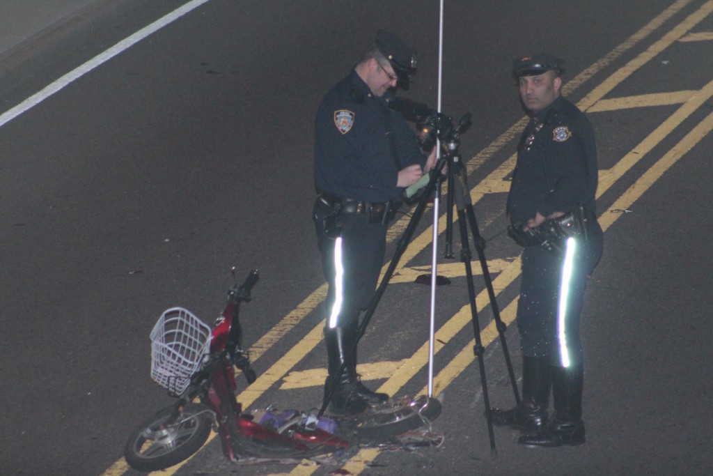 Members of the NYPD Highway Patrol Collision Investigation Squad near the scooter involved in a crash in Glendale Saturday morning.