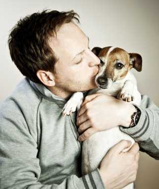 Man kissing his dog