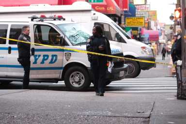 Officers at the corner of Roosevelt Avenue and 81st Street in Jackson Heights, where a man was beaten to death on Sunday morning.