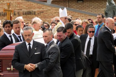 Grieving family and friends of Karina Vetrano carry her coffin out of St. Helen's Church in Howard Beach on Saturday.
