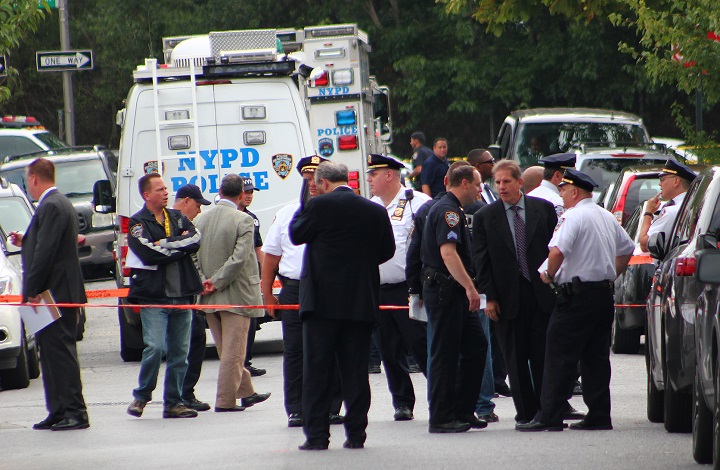 Police on the scene Monday afternoon after officers shot a suspected burglar in Maspeth.