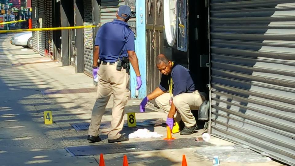 Crime scene investigators at the scene of an early morning shooting outside a Richmond Hill hookah lounge on Saturday.