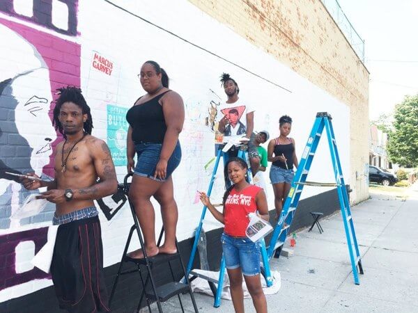 Artists make a mural of A Tribe Called Quest’s message